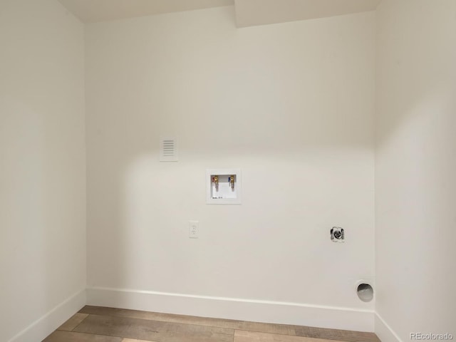 clothes washing area featuring electric dryer hookup, hardwood / wood-style floors, and hookup for a washing machine