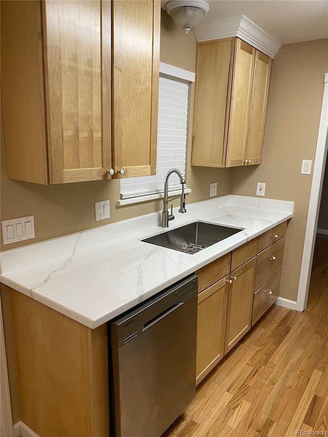 kitchen featuring light stone countertops, sink, black dishwasher, and light hardwood / wood-style floors