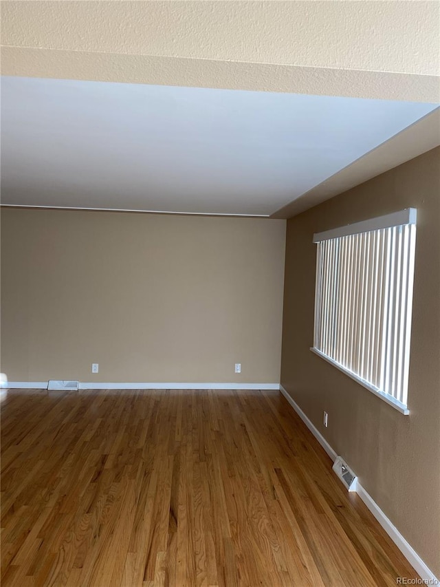 unfurnished room featuring wood-type flooring