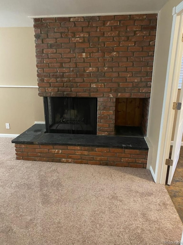 room details featuring carpet flooring and a fireplace