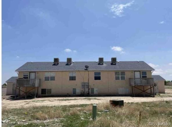 rear view of property featuring cooling unit