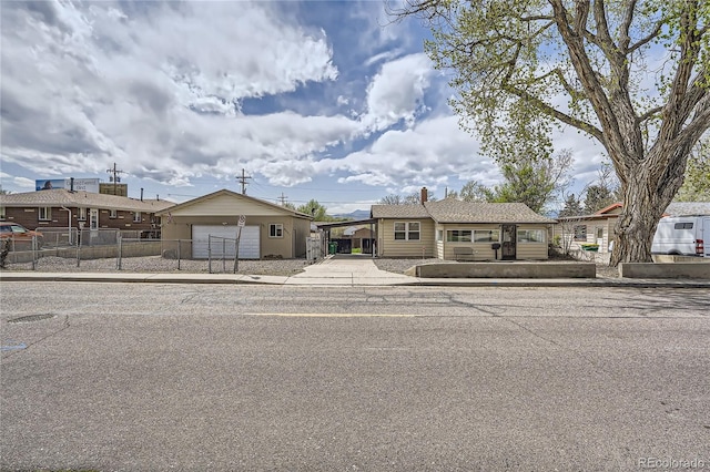 4835 Harlan St, Wheat Ridge, CO 80033 - view of front facade with a garage, fence, and concrete driveway