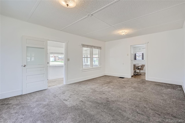 4835 Harlan St, Wheat Ridge, CO 80033 - carpeted empty room featuring a textured ceiling, a desk, and baseboards