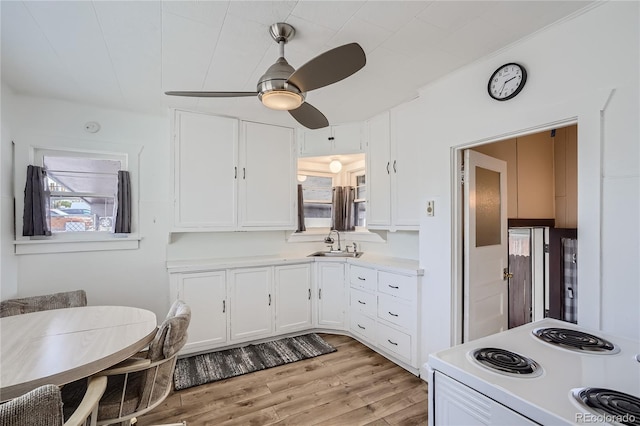 4835 Harlan St, Wheat Ridge, CO 80033 - kitchen featuring white electric range, white cabinets, light countertops, and a ceiling fan