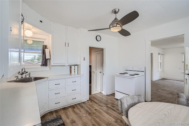4835 Harlan St, Wheat Ridge, CO 80033 - kitchen featuring white appliances, a sink, white cabinets, light countertops, and a ceiling fan