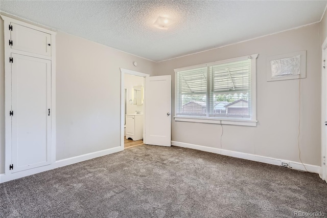 4835 Harlan St, Wheat Ridge, CO 80033 - unfurnished bedroom featuring carpet flooring, a textured ceiling, baseboards, and ensuite bath