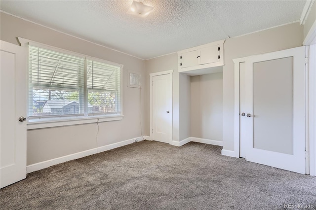 4835 Harlan St, Wheat Ridge, CO 80033 - unfurnished bedroom featuring carpet flooring, a textured ceiling, and baseboards