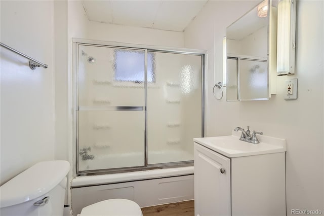 4835 Harlan St, Wheat Ridge, CO 80033 - full bathroom featuring toilet, vanity, and bath / shower combo with glass door
