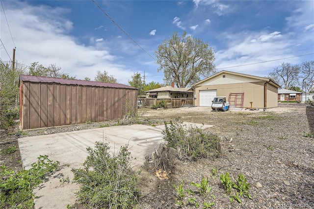 4835 Harlan St, Wheat Ridge, CO 80033 - view of yard featuring an outbuilding, fence, and a garage