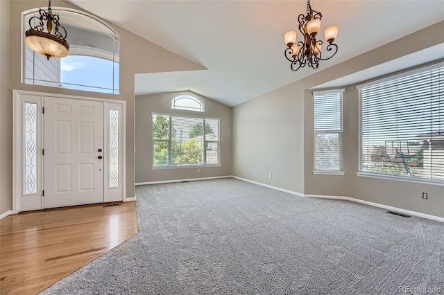 22436 E Maplewood Pl, Aurora, CO 80015 - entryway featuring a chandelier, vaulted ceiling, and wood finished floors