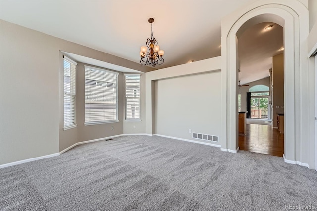 22436 E Maplewood Pl, Aurora, CO 80015 - carpeted spare room with a chandelier and arched walkways