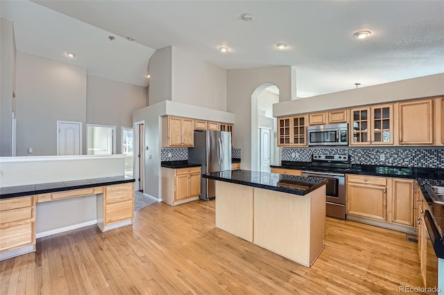 22436 E Maplewood Pl, Aurora, CO 80015 - kitchen with appliances with stainless steel finishes, high vaulted ceiling, tasteful backsplash, glass insert cabinets, and a kitchen island