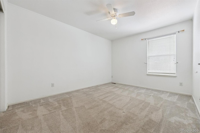 empty room featuring ceiling fan and light colored carpet