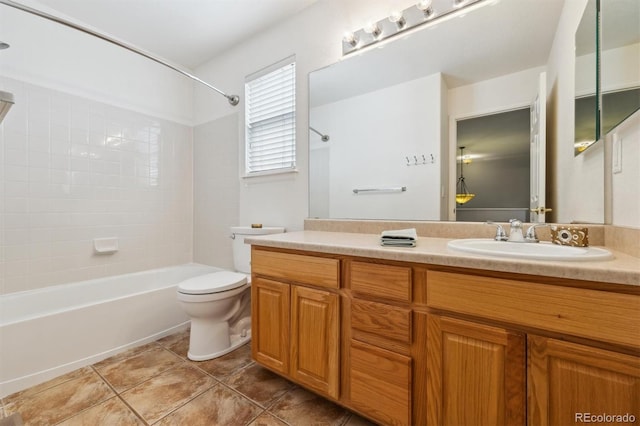 full bathroom featuring vanity, toilet, tiled shower / bath combo, and tile patterned flooring