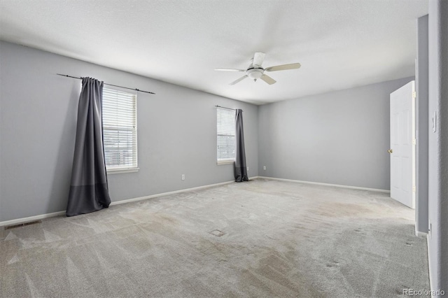 unfurnished room featuring ceiling fan and light colored carpet