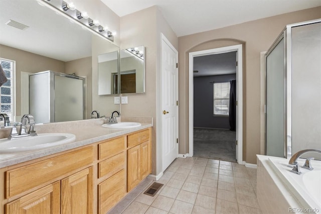 bathroom with tile patterned floors, separate shower and tub, and vanity