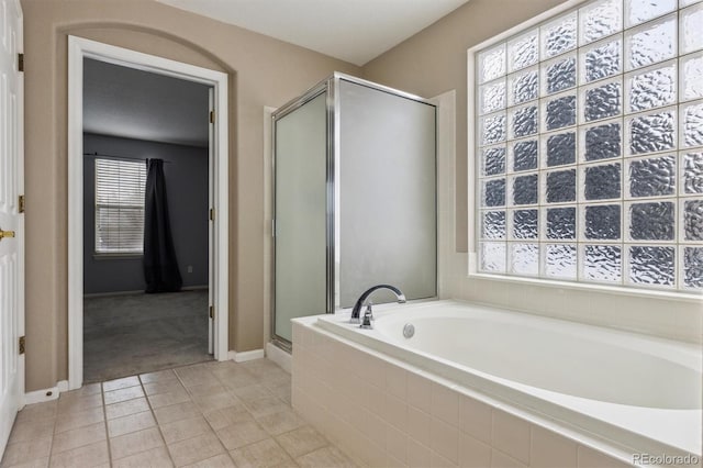 bathroom featuring tile patterned flooring and plus walk in shower