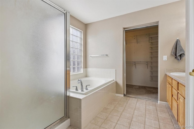 bathroom with vanity, tile patterned flooring, and independent shower and bath