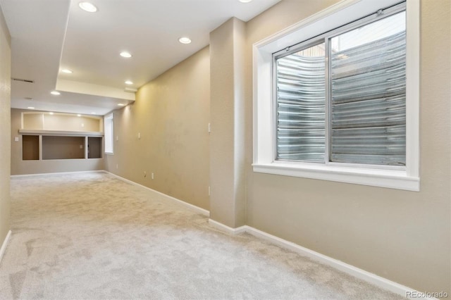 empty room featuring a fireplace and light carpet