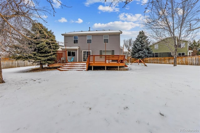 snow covered rear of property featuring a wooden deck