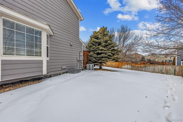 yard layered in snow with central AC unit