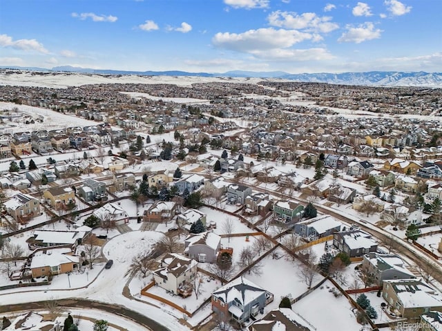 snowy aerial view with a mountain view