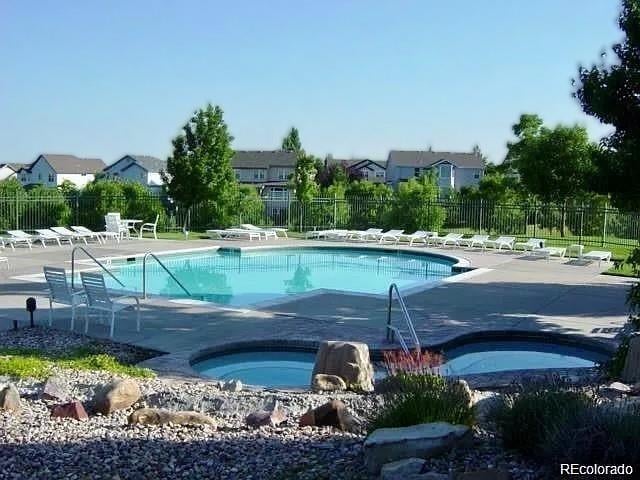 view of swimming pool with a patio area and a community hot tub