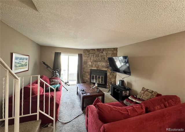 carpeted living room with a stone fireplace and a textured ceiling