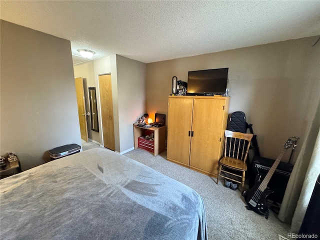 bedroom with a textured ceiling and carpet flooring