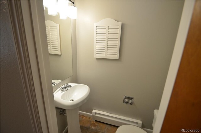 8450 Mason Cir, Westminster, CO 80031 - bathroom featuring baseboard heating, baseboards, and toilet