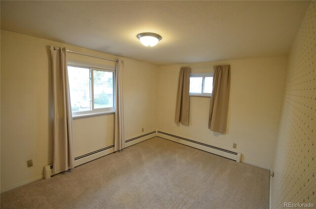 8450 Mason Cir, Westminster, CO 80031 - empty room with light colored carpet, baseboards, and a baseboard radiator