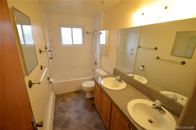 8450 Mason Cir, Westminster, CO 80031 - full bathroom with bathing tub / shower combination, toilet, double vanity, and stone finish floors
