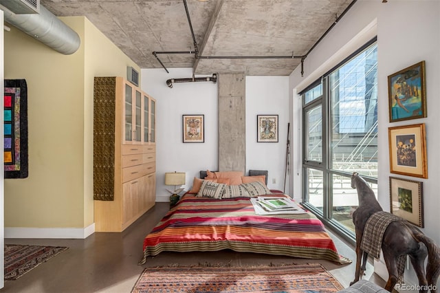 bedroom with concrete flooring, baseboards, and visible vents