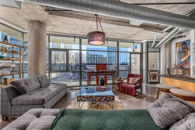 living room featuring a wall of windows and wood finished floors