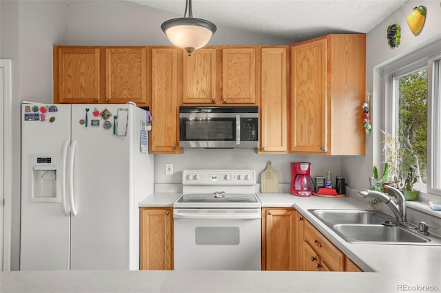 3312 Meadow Ave, Broomfield, CO 80020 - kitchen featuring white appliances, light countertops, vaulted ceiling, and hanging light fixtures