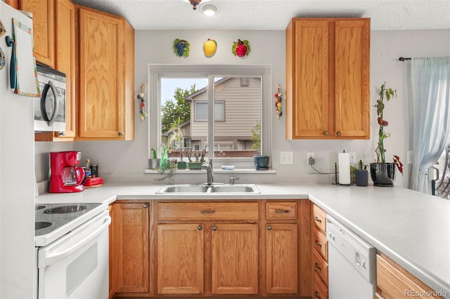 3312 Meadow Ave, Broomfield, CO 80020 - kitchen with white appliances, light countertops, and a textured ceiling