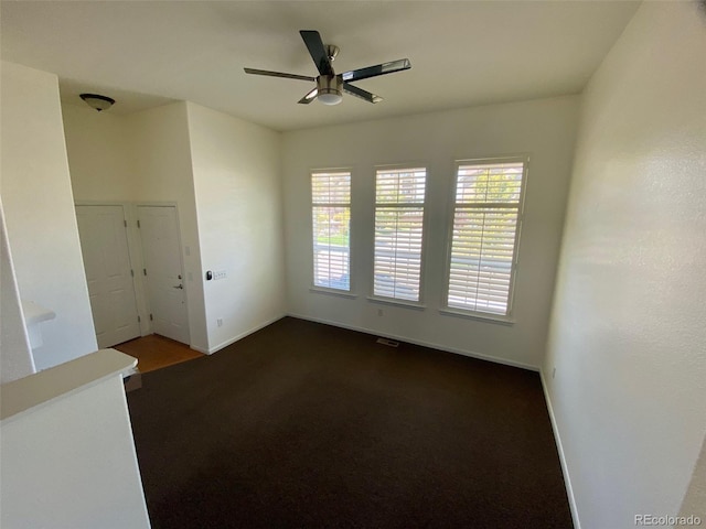 empty room featuring carpet flooring, ceiling fan, and plenty of natural light