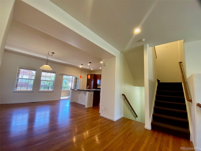 unfurnished living room with dark hardwood / wood-style floors