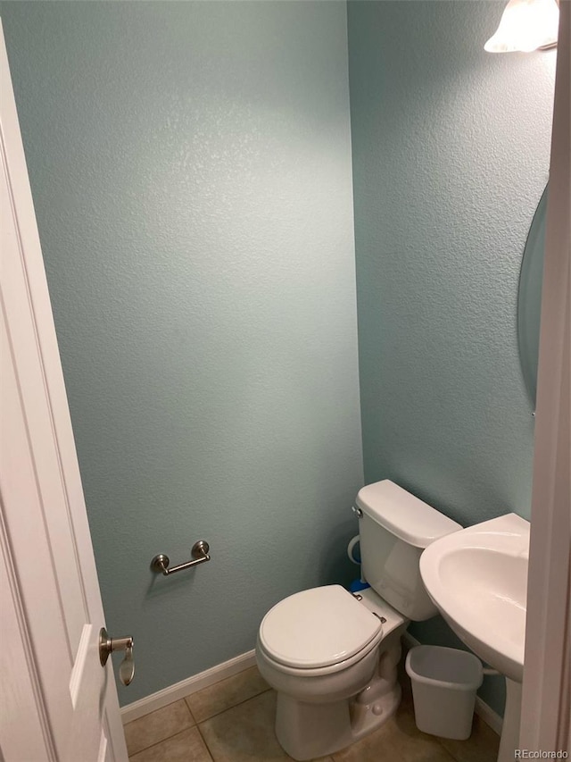 bathroom with tile patterned floors, sink, and toilet