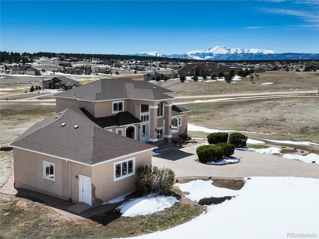 snowy aerial view with a mountain view