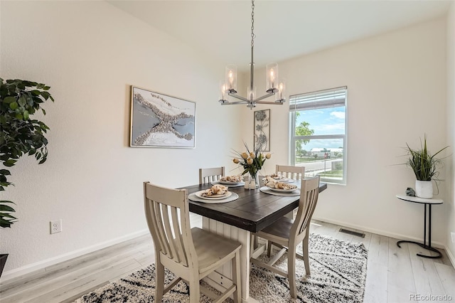 401 Quincy Rr Ave, Keenesburg, CO 80643 - dining room with a chandelier, light wood-type flooring, and baseboards