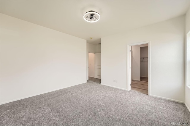 401 Quincy Rr Ave, Keenesburg, CO 80643 - unfurnished bedroom featuring carpet floors, baseboards, a walk in closet, and a closet