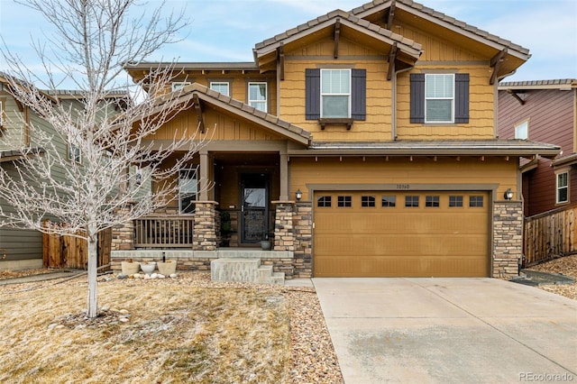 craftsman house featuring board and batten siding, stone siding, driveway, and an attached garage