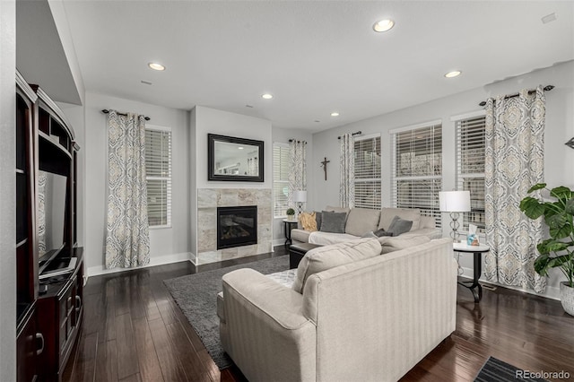 living area with recessed lighting, dark wood-style flooring, a fireplace, and baseboards