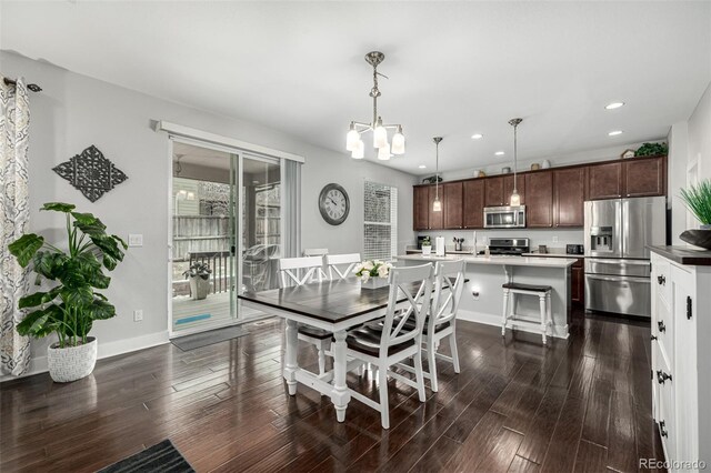 dining area featuring dark wood-style floors, baseboards, an inviting chandelier, and recessed lighting