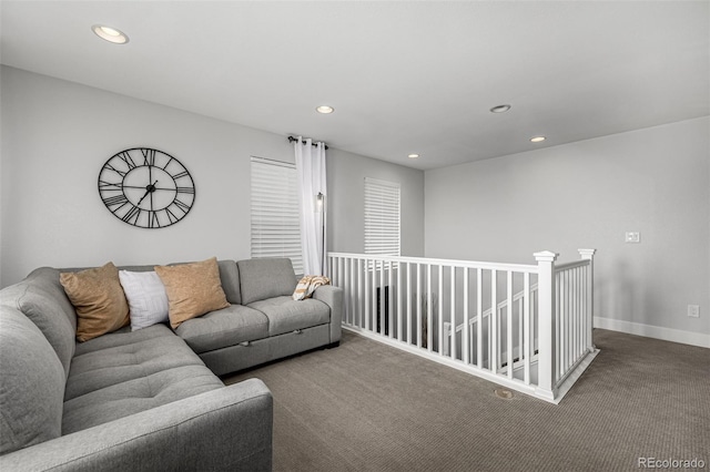 living area with baseboards, dark carpet, and recessed lighting