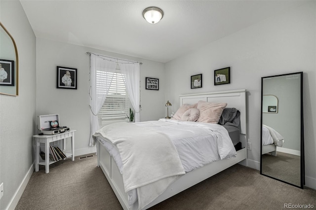 carpeted bedroom featuring visible vents and baseboards