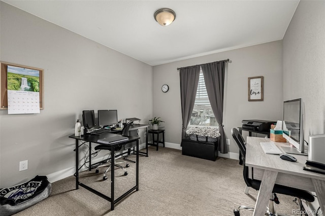 home office with baseboards and light colored carpet