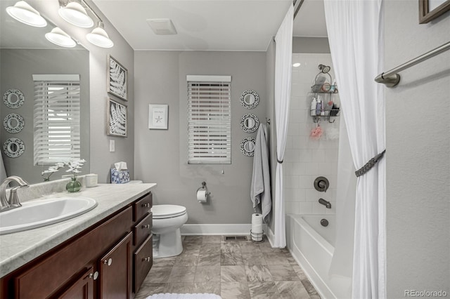 bathroom featuring marble finish floor, shower / bathtub combination with curtain, toilet, vanity, and baseboards