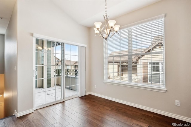 unfurnished dining area with a notable chandelier and hardwood / wood-style flooring